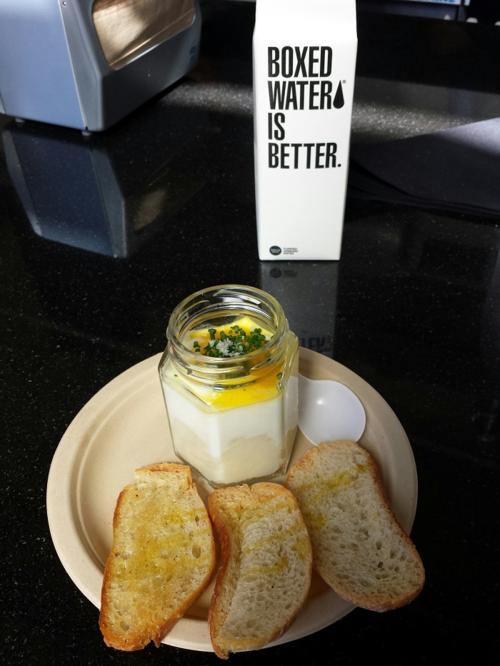 SLUT a coddled egg on top of a smooth potato purée, poached in a glass jar, topped with gray salt and chives, served with slices of baguette